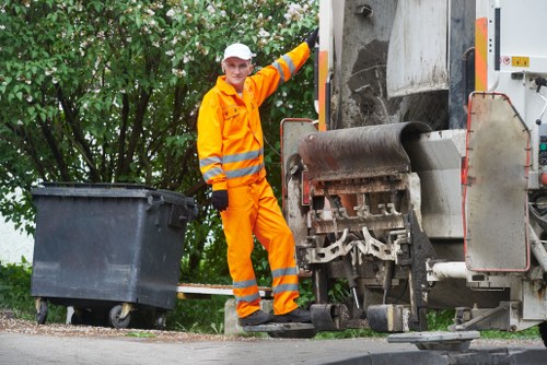 Crew loading household waste from a flat for removal
